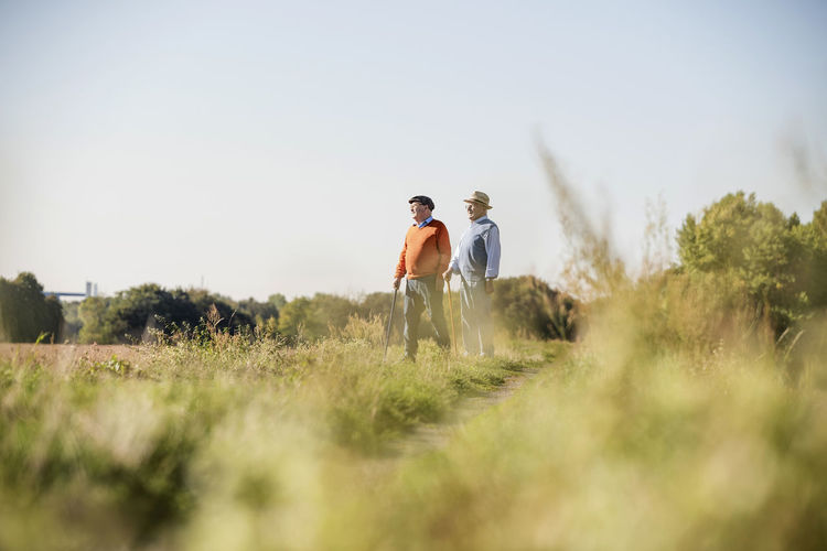 Two old friends taking a stroll through the fields, talking about old times