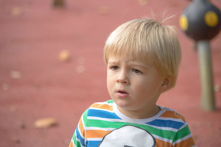 Cute boy looking away at playground