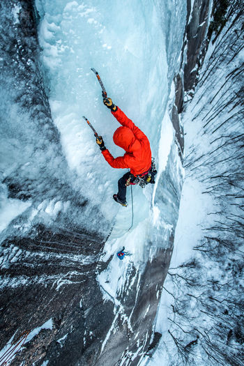 Man ice climbing on cathedral ledge in north conway, new hampshire
