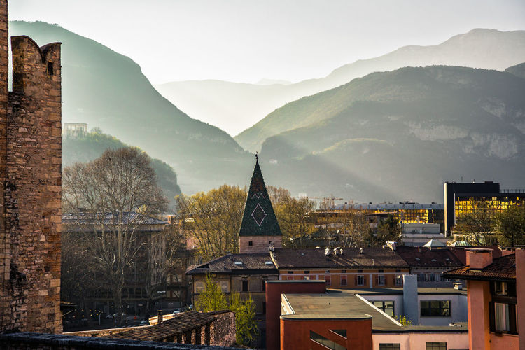 City skyline near dominates during sunset with silhouette of mountains , trento, italy