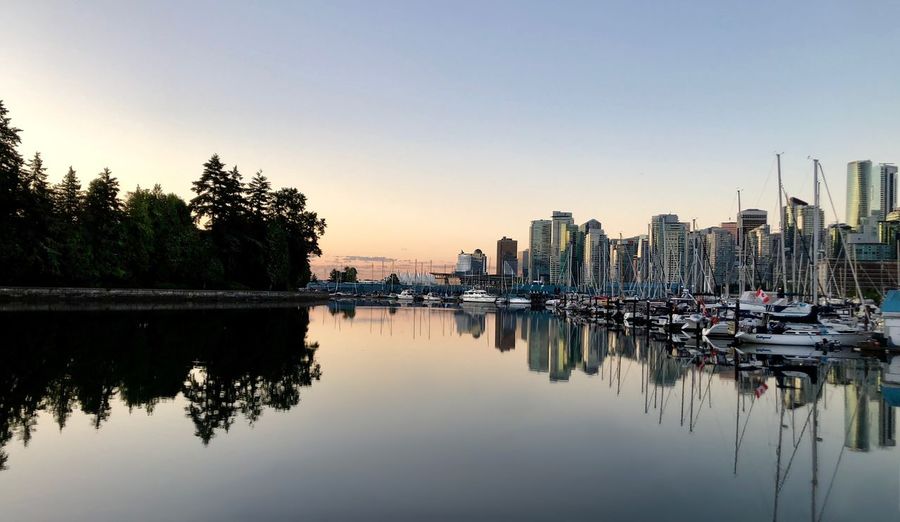 Reflection of buildings in lake at sunset