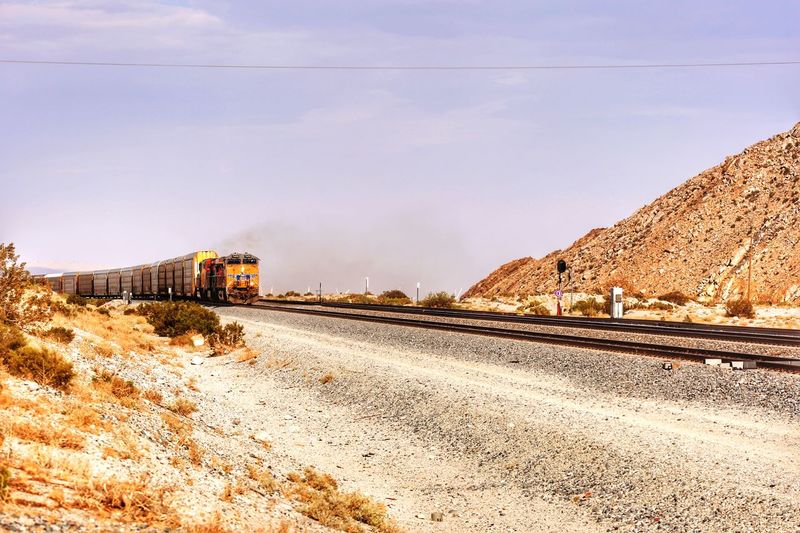 Train in desert against sky