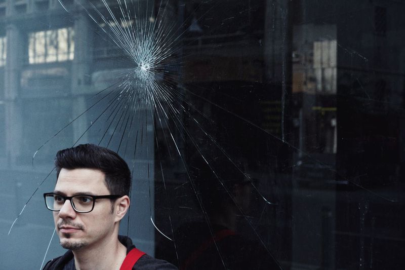 Man against broken glass