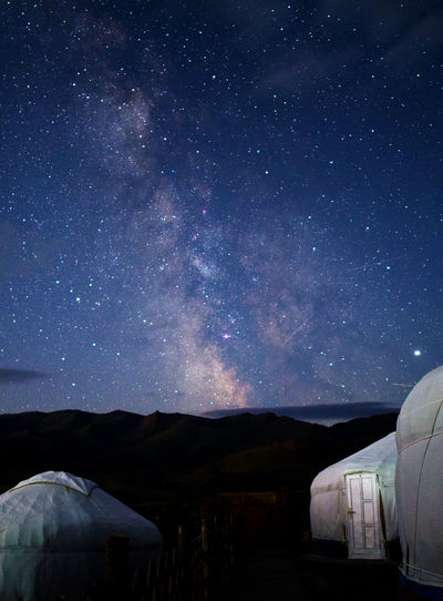 Built structures on land against star field