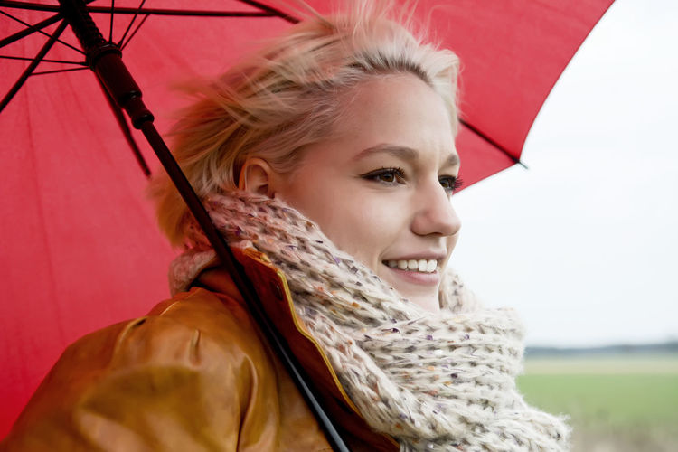 Portrait of a smiling young woman looking away