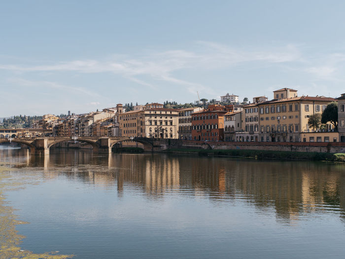 Florence city view with ponte vecchio and reflection of houses in the arno