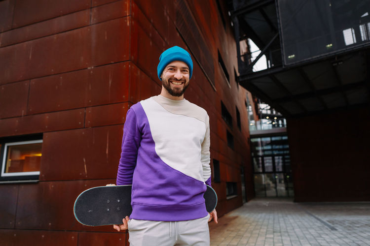 Portrait of a skater. a skateboarder at an urban location looks into the camera