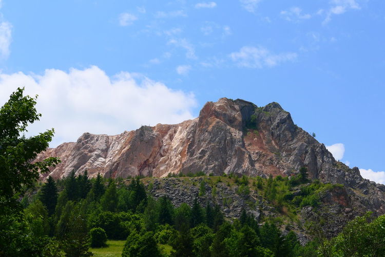 Low angle view of rocks on mountain against sky