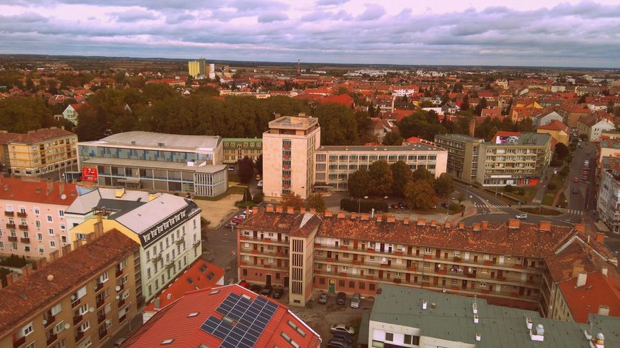 High angle view of cityscape against cloudy sky