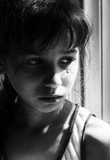 Close-up of sad girl crying at home