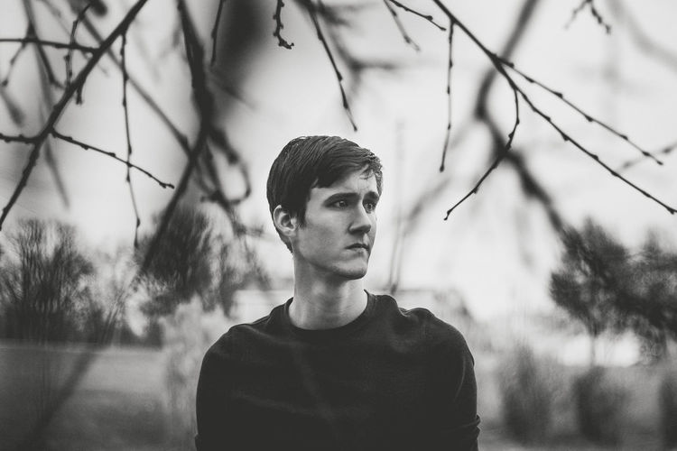 Young man against trees