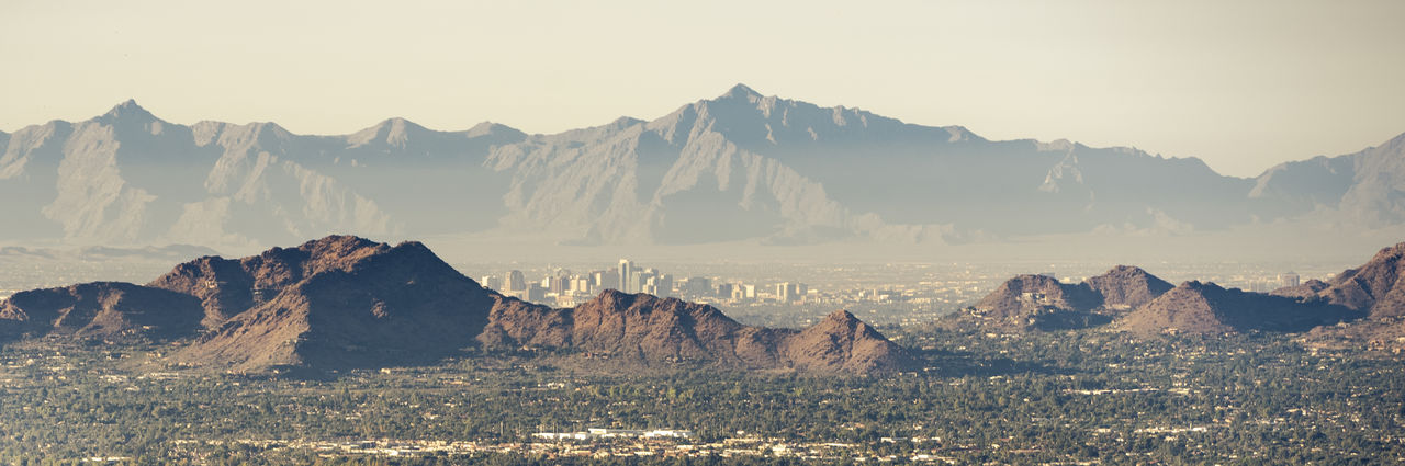 Phoenix skyline through camelback mountain and pollution.