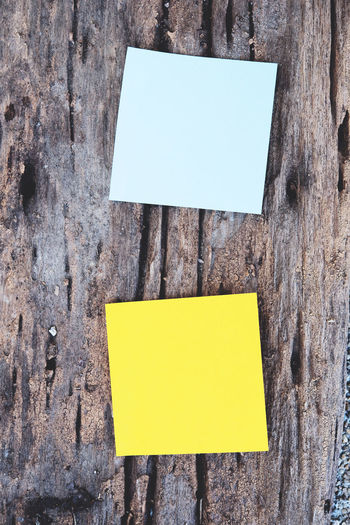 Close-up of adhesive notes on wood