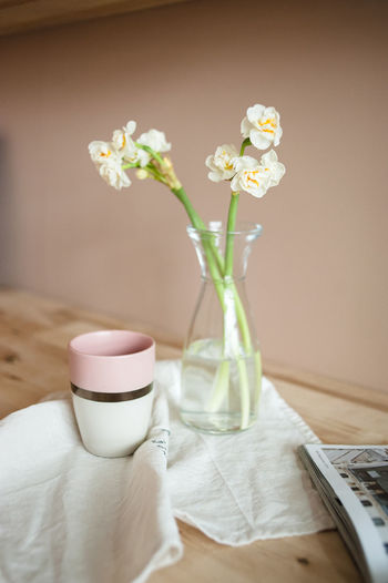 Close-up of white flower vase on table at home