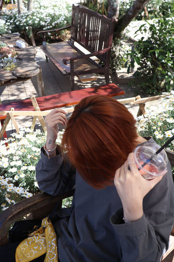 Rear view of woman drinking glass