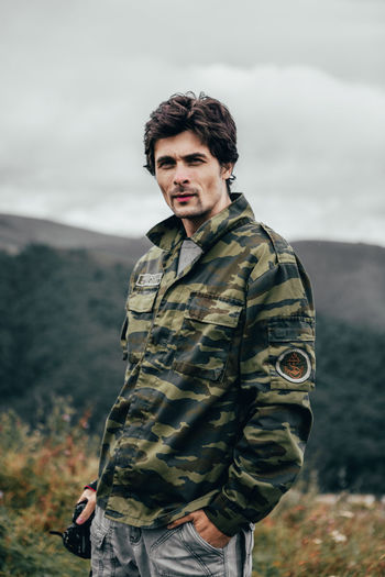 Portrait of man standing against mountains