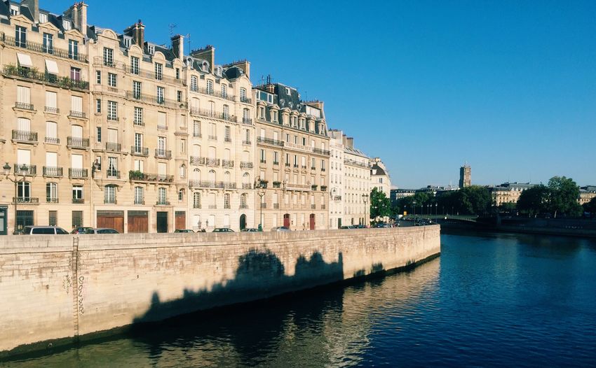 Buildings at ile de la cite by seine river against sky