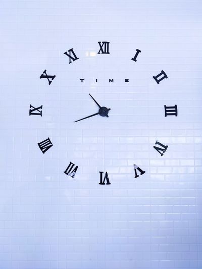 Low angle view of clock on wall