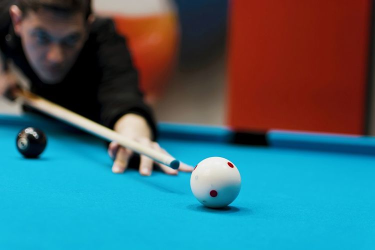 Man playing snooker on blue table