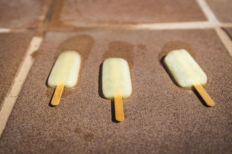 Three ice creams melting on the ground