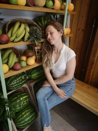 Young woman smiling with fruits