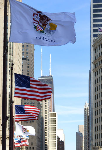 Low angle view of flag against buildings in city