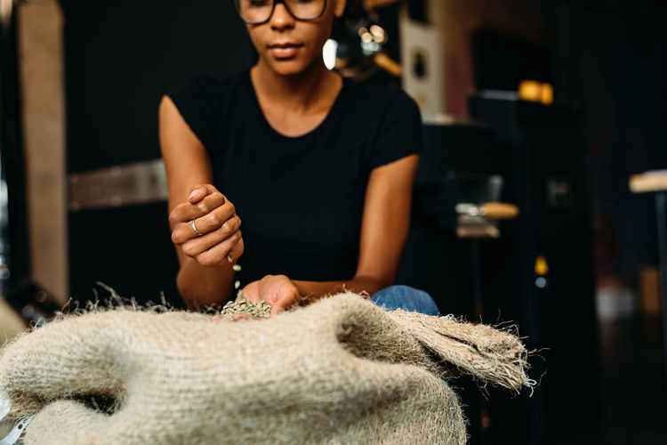 African American Beans Coffee Coffee Shop Examination Females Hands Quality Work Workplace Authentic Businesswoman Cafe Casual Clothing Factory Front View Indoors Lifestyles One Person Owner Produce Real People Roasting Sack