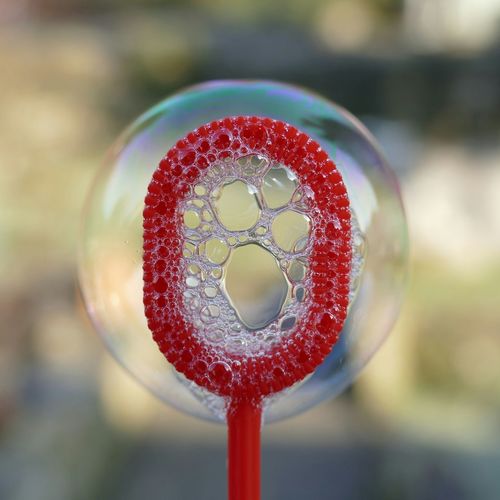 Close-up of red bubble wand