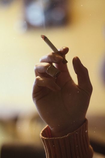 Person holding cigarette in hand