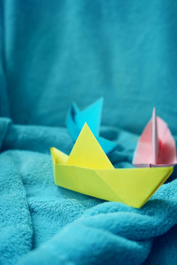 Close-up of paper boat on towel
