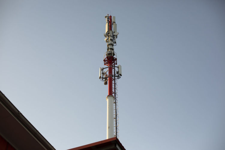 Communication antenna. radio tower in the city. repeater against the sky.
