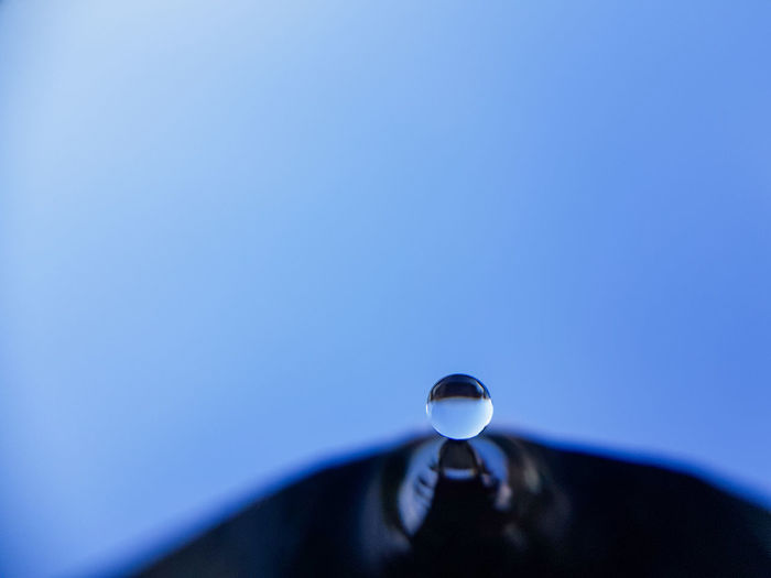 Low angle view of lamp against blue sky