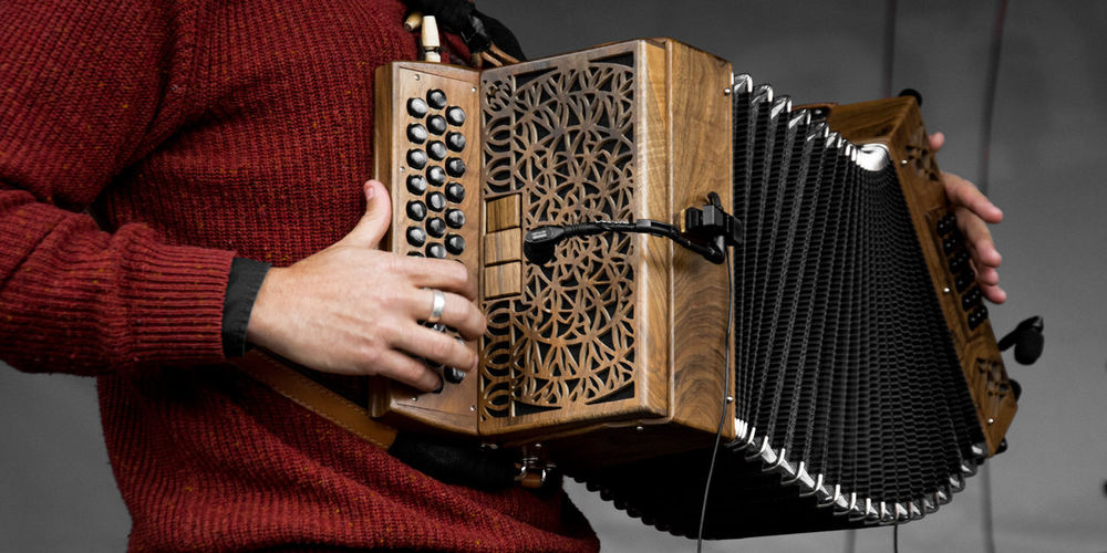 Midsection of man playing accordion
