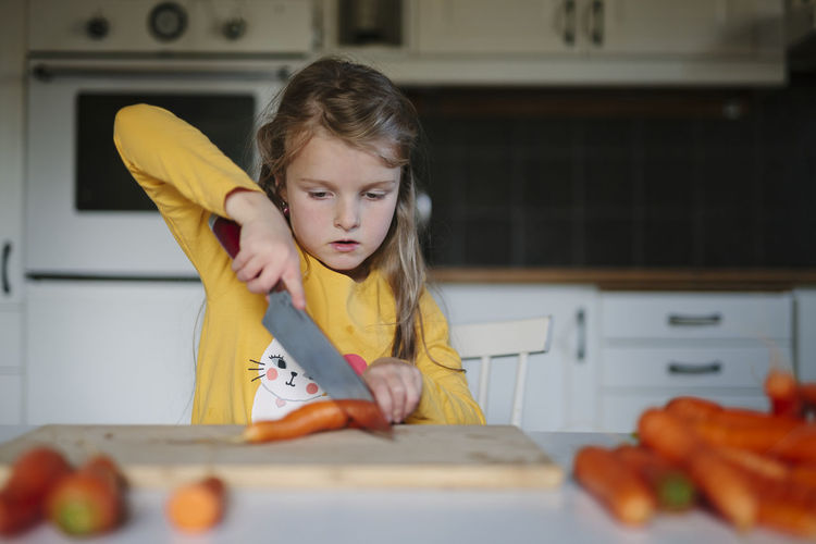 Girl cutting carrot