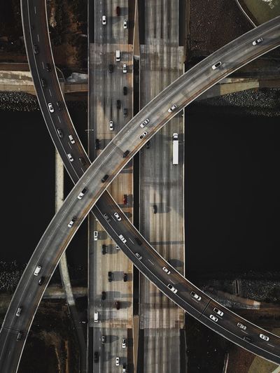 High angle view of vehicles on road over river in city