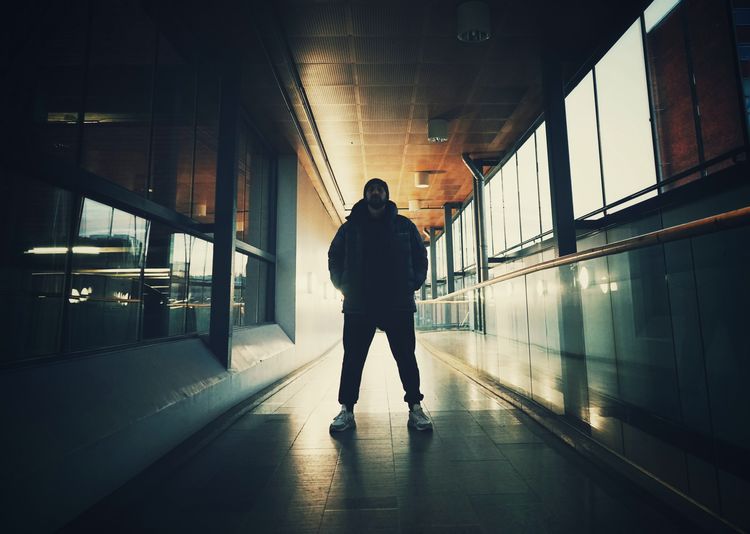 Rear view of man walking in corridor of building