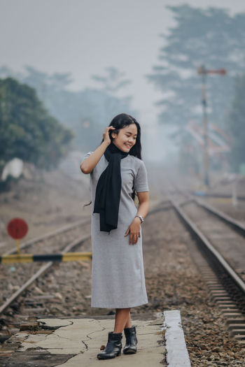 Full length of woman standing on railroad track