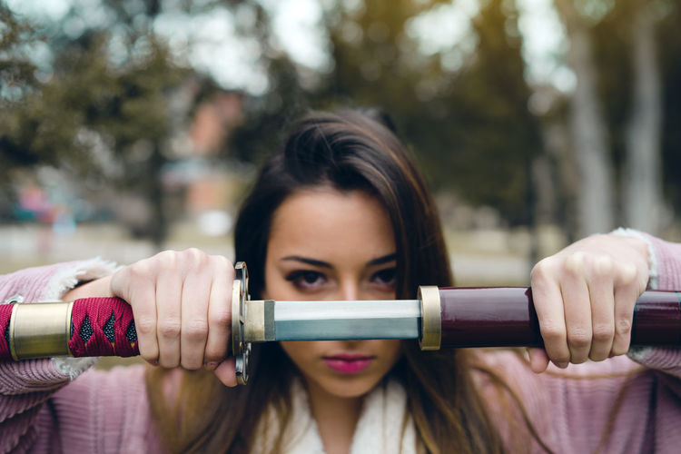 Portrait of teenage girl holding sword