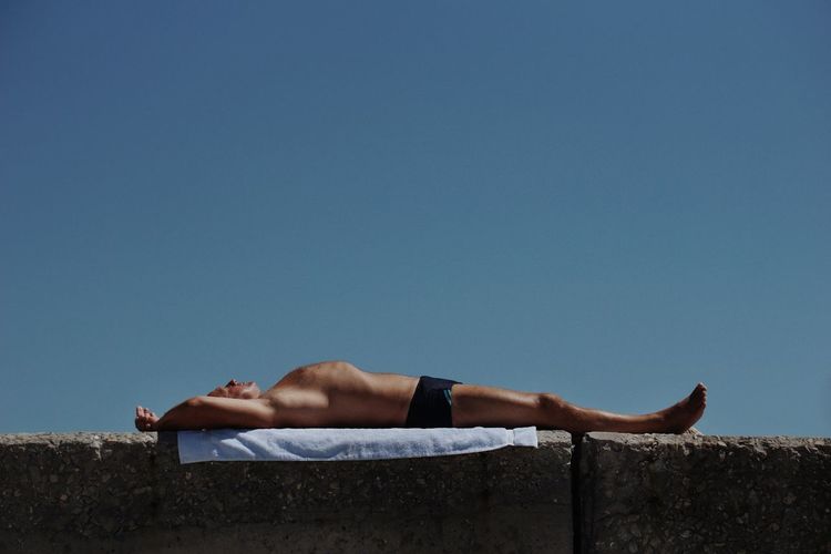 Men Shirtless Summer Sky Sleeping Shore Sunbathing Beach Towel Beach Holiday Eyes Closed Napping Clear Sky Calm Lying Visual Creativity Summer Exploratorium #FREIHEITBERLIN Creative Space The Still Life Photographer - 2018 EyeEm Awards The Traveler - 2018 EyeEm Awards