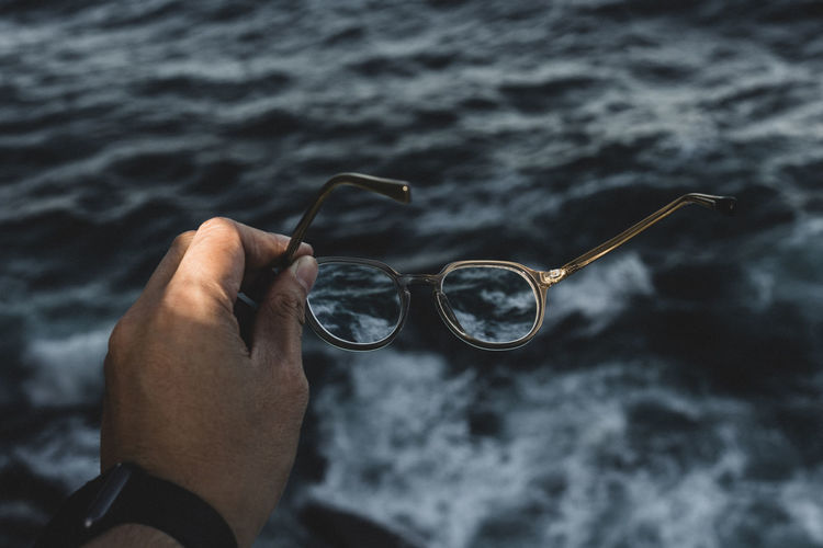 Close-up of hand holding glasses