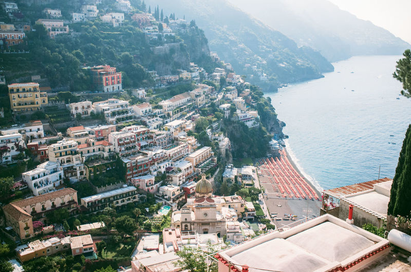 High angle view of buildings on mountains by sea at positano