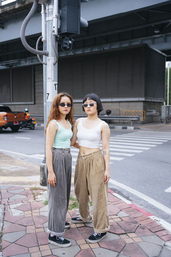 Full length of lesbian couple standing on road