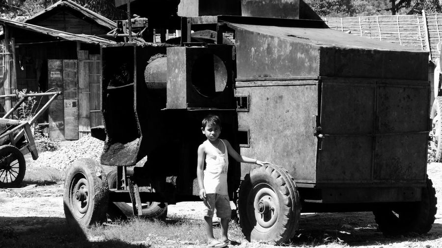 Boy standing by machinery