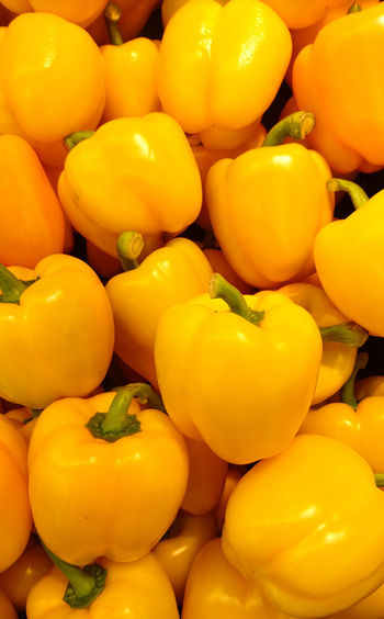 Full frame shot of yellow bell peppers for sale at market