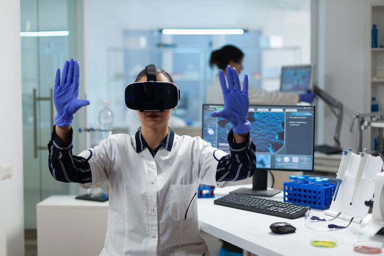 Scientist using virtual reality simulator at laboratory
