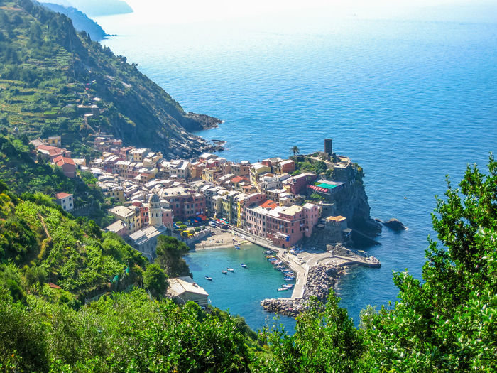 High angle view of town and mountain by sea in cinque terre