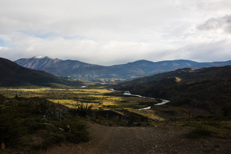 Scenic view of river amidst mountains against sky