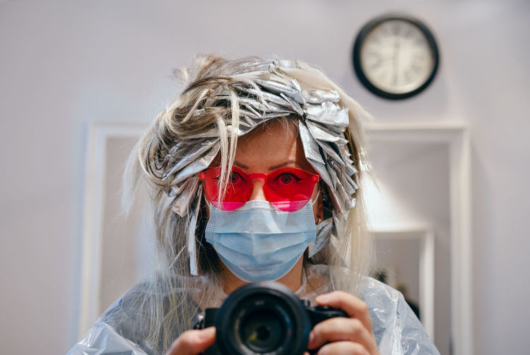 Portrait of woman at beauty salon photographing