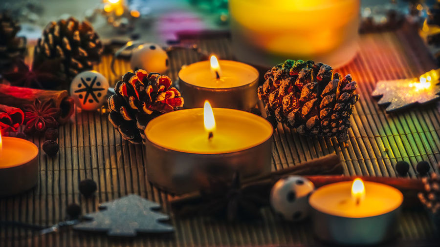 Close-up of burning tea lights decorations and spices on table