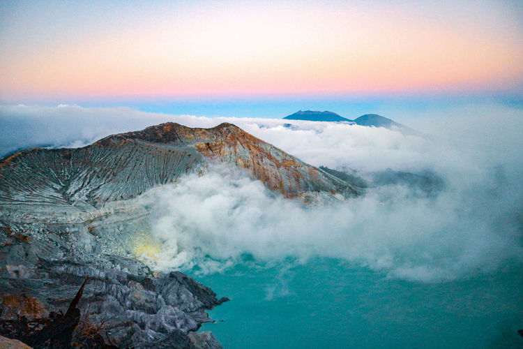 Panoramic view of volcanic mountain against sky during sunrise in ijen crater lake